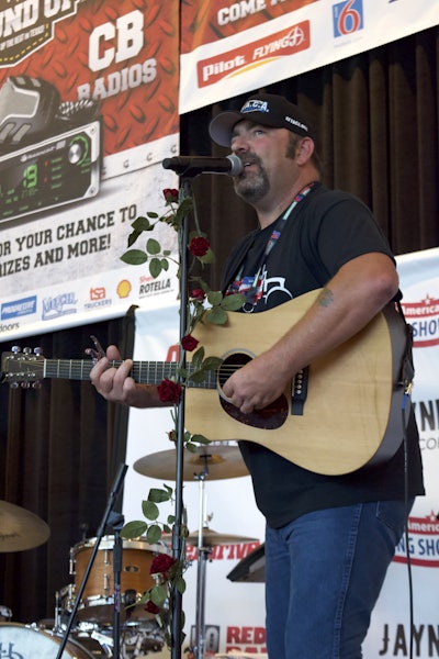Trucker Talent Search winner Taylor Barker sings at the Great American Trucking Show in Dallas last August. (Photo by Max Heine)