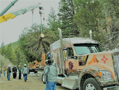 This scene from the tree’s Nov. 6 harvesting shows some of the graphics on the side of the W990 hood, showcasing New Mexico’s state flag, along with Ship Rock, a 7,177-foot-high mountain rock that resembles a 19th century clipper ship.