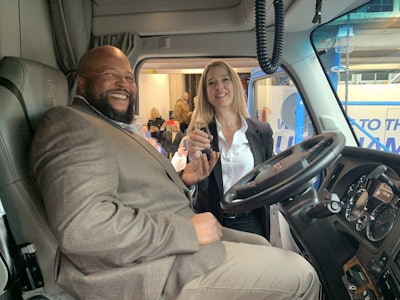 Roehl Transport driver Joseph Campbell receives the keys to his brand-new Kenworth T680 from Lisa Berreth, Kenworth marketing director. Campbell won the Transition Trucking: Driving for Excellence award that recognizes rookie military veteran truckers.