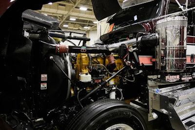 The glider is equipped with a Cat 3406E with an 18-speed. Parts of the engine are painted to match the exterior and the rest of the truck’s theme.