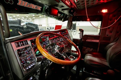 All of the gauges on the dash have been switched to chrome. The back of the visor reads “Black Cherry” in the color scheme of the exterior.