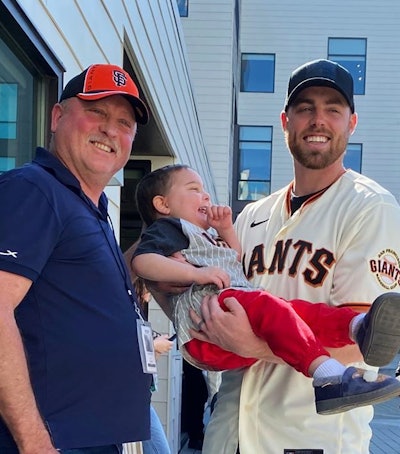 Howard Salmon and Liam with Giants reliever Sam Coonrod.