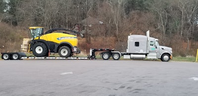 Semi truck hauling a tractor