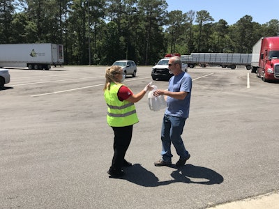 Wesley Drake, a driver for Abilene Motor Express, receives his care package from a Chick-fil-A employee.