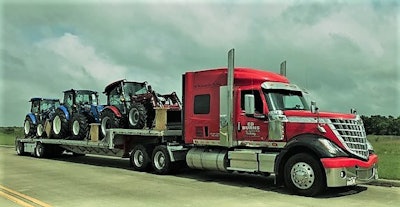 An Ed Burns Trucking Lonestar hauling tractors out of the port of Houston.
