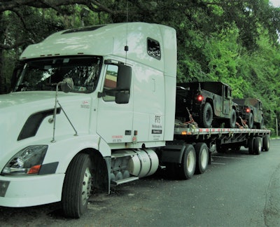Among items hauled by PTS Worldwide for the Department of Defense are loads like this – military vehicles and other rolling equipment. PTS is a member of the National Defense Transportation Association and both the Owner-Operator Independent Drivers Association and the American Trucking Associations, where Rhonda Brown serves on the board of directors of the Associations’ government freight conference.