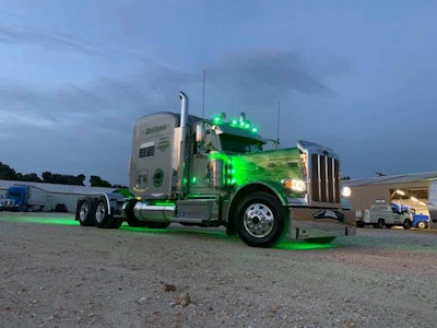 Kris Keel's 2019 Peterbilt 389 with lights on at dusk
