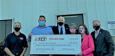 TCI team members posing with their oversize check.