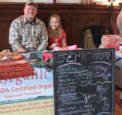 John Malayter and daughter Emma selling produce from the family’s organic farm.