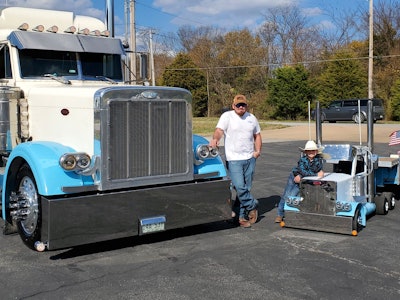 Brandon Davis, left, with his 1994 Peterbilt 379 and his son, Remington “Rooster” Davis (right) with his custom-built “WeePete” 379 replica.