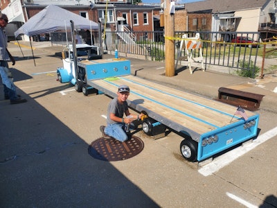 Brandon Davis built the step-deck replica himself, modeling it after his own Wilson trailer he uses to haul building materials locally around southwest Missouri. Shown is Rooster making sure his tires shine for judges.