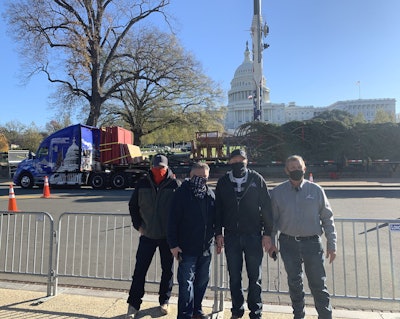 Representing Apex Transportation at the tree unloading on Nov. 20 were, from left: Theron Schmalzried, U.S. Capitol Christmas Tree driver; Dennis Atencio, vice president of risk management; Walt Schattinger; president; and Glenn McCormack, driver supervisor. (Photo by Paul Feenstra)