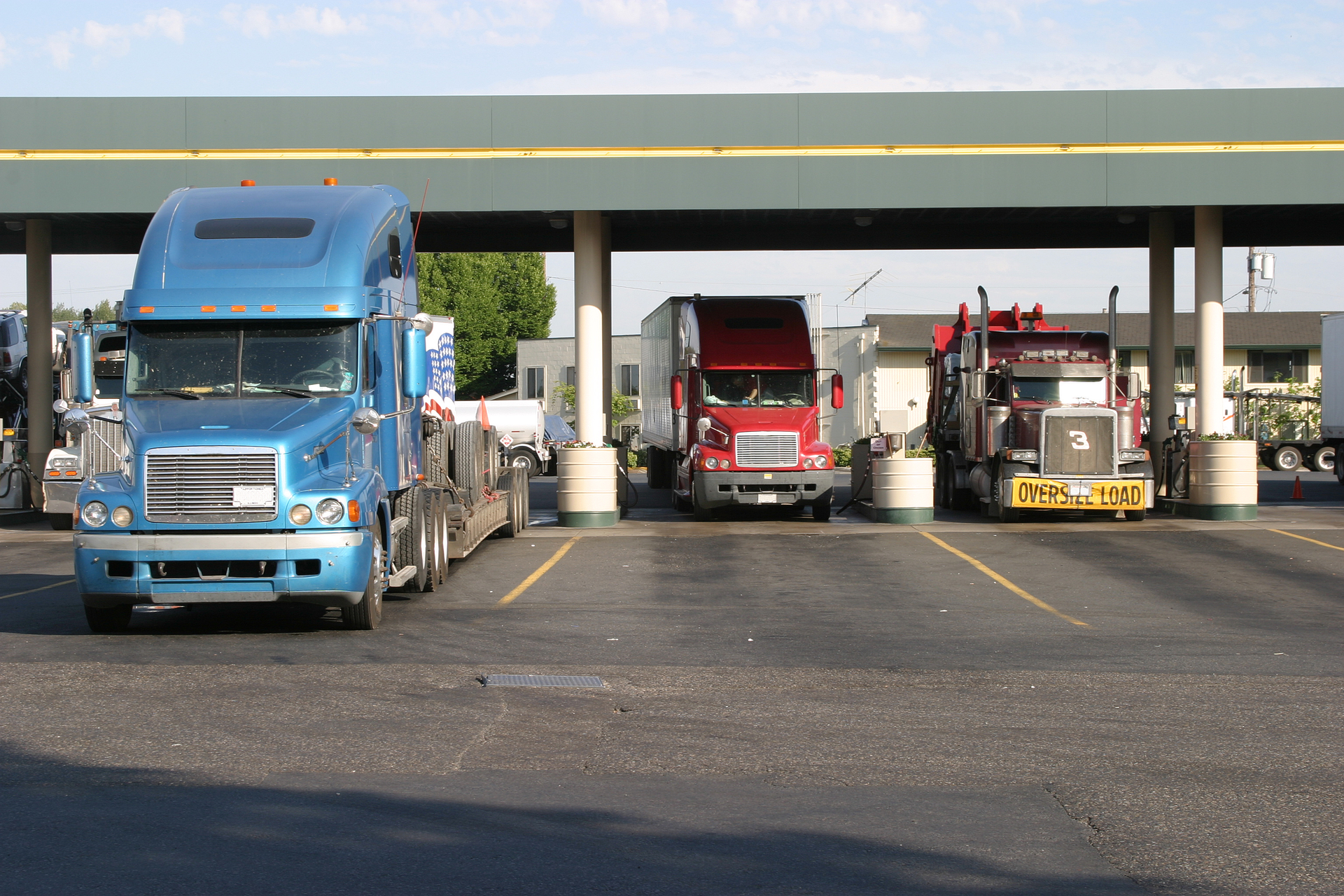 semi trucks fueling at truck stop