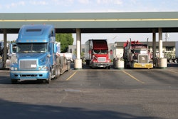 semi trucks fueling at truck stop