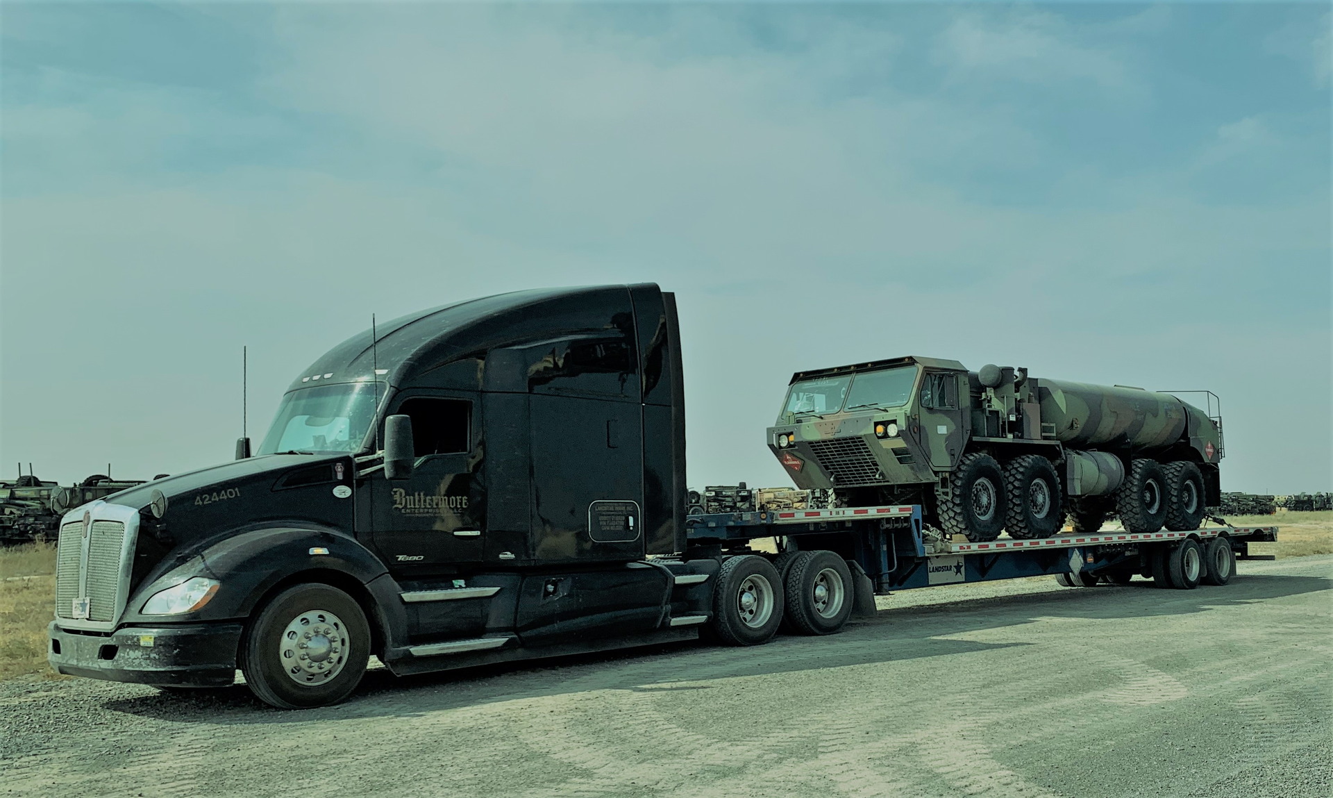 Lance Buttermore's 2015 Kenworth t680 hauling military machinery