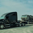 Lance Buttermore's 2015 Kenworth t680 hauling military machinery