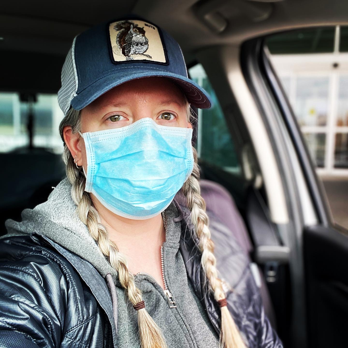 Amy Watson wearing a hat with a patch of a squirrel on the front