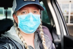 Amy Watson wearing a hat with a patch of a squirrel on the front