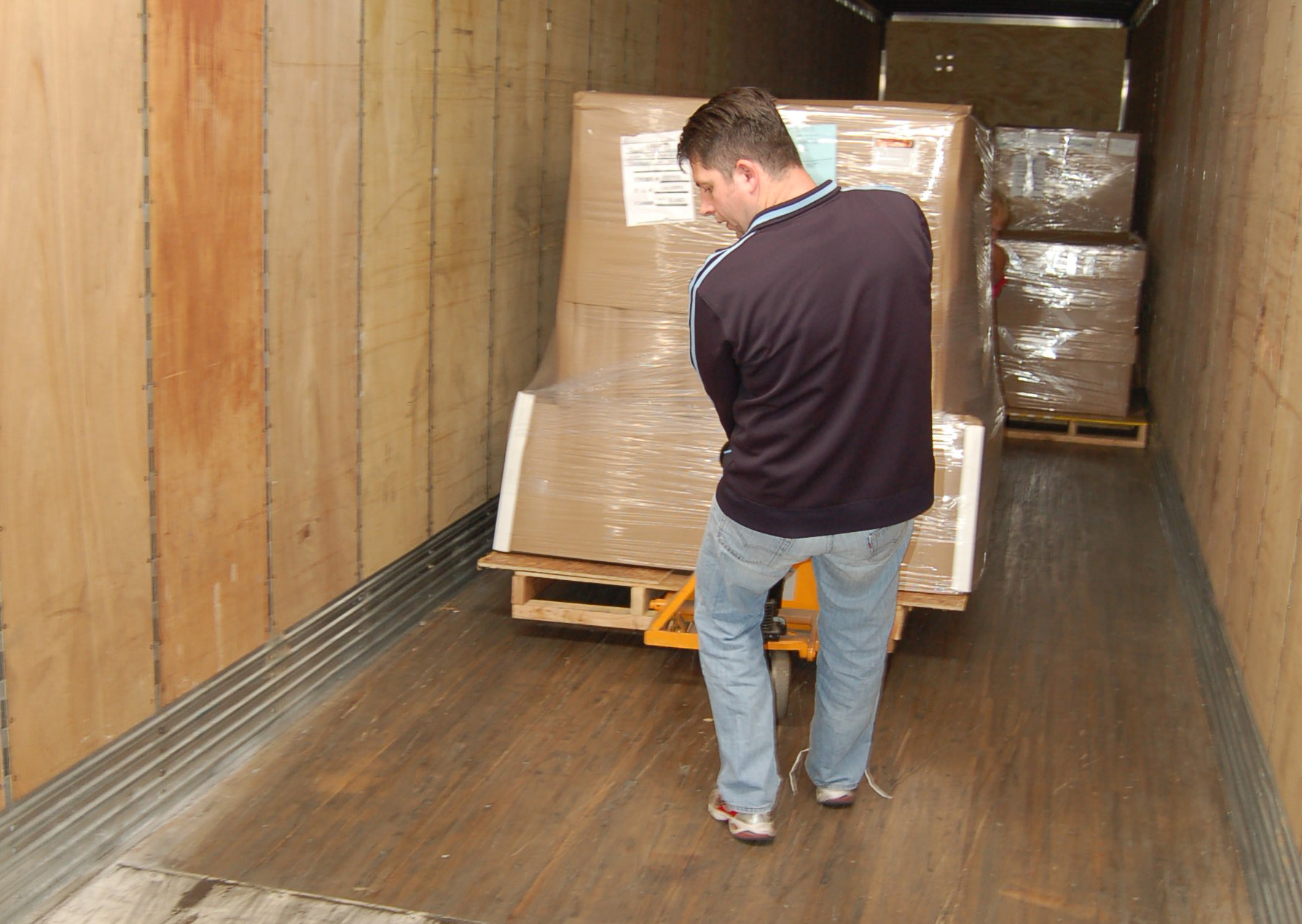 Operator unloading a dry van trailer