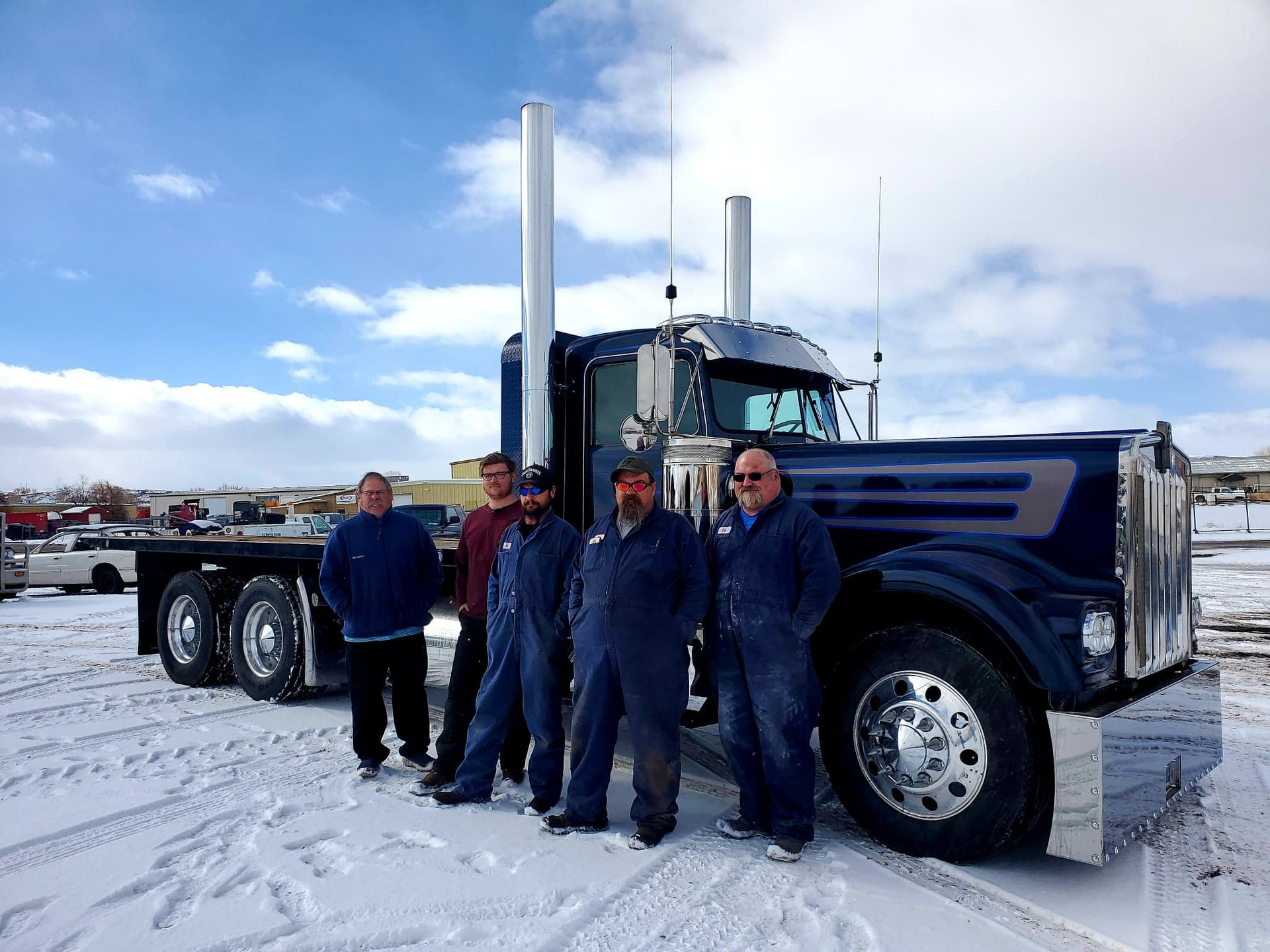 Dustbusters owner Craig Prete standing next to Austin Oliver, Kipp Knight, Cole Potter, and Martin Herman in front of Prete's 1980 Kenworth W900A