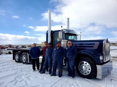 Dustbusters owner Craig Prete standing next to Austin Oliver, Kipp Knight, Cole Potter, and Martin Herman in front of Prete's 1980 Kenworth W900A