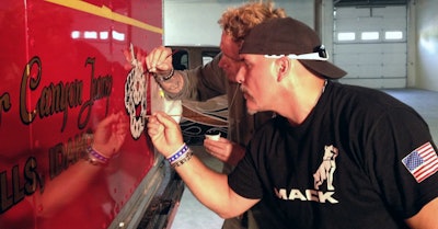 Robb Mariani and Lathan McKay recreating some of the original paint detailing on the Mack