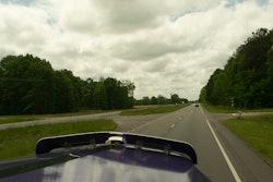 Overcast sky and highway from passenger's seat of a semi-truck