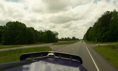 Overcast sky and highway from passenger's seat of a semi-truck