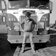 Jobie Vaden standing in front of a Keaton Truck Lines White-Freightliner truck