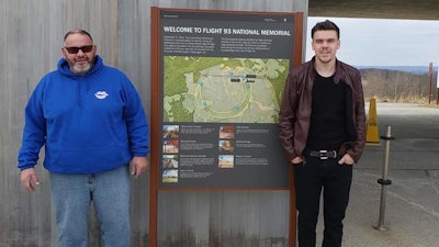Anthony Scott Townley Sr. and his son, Anthony Townley Jr., standing beside the Flight 93 National Memorial welcome sign