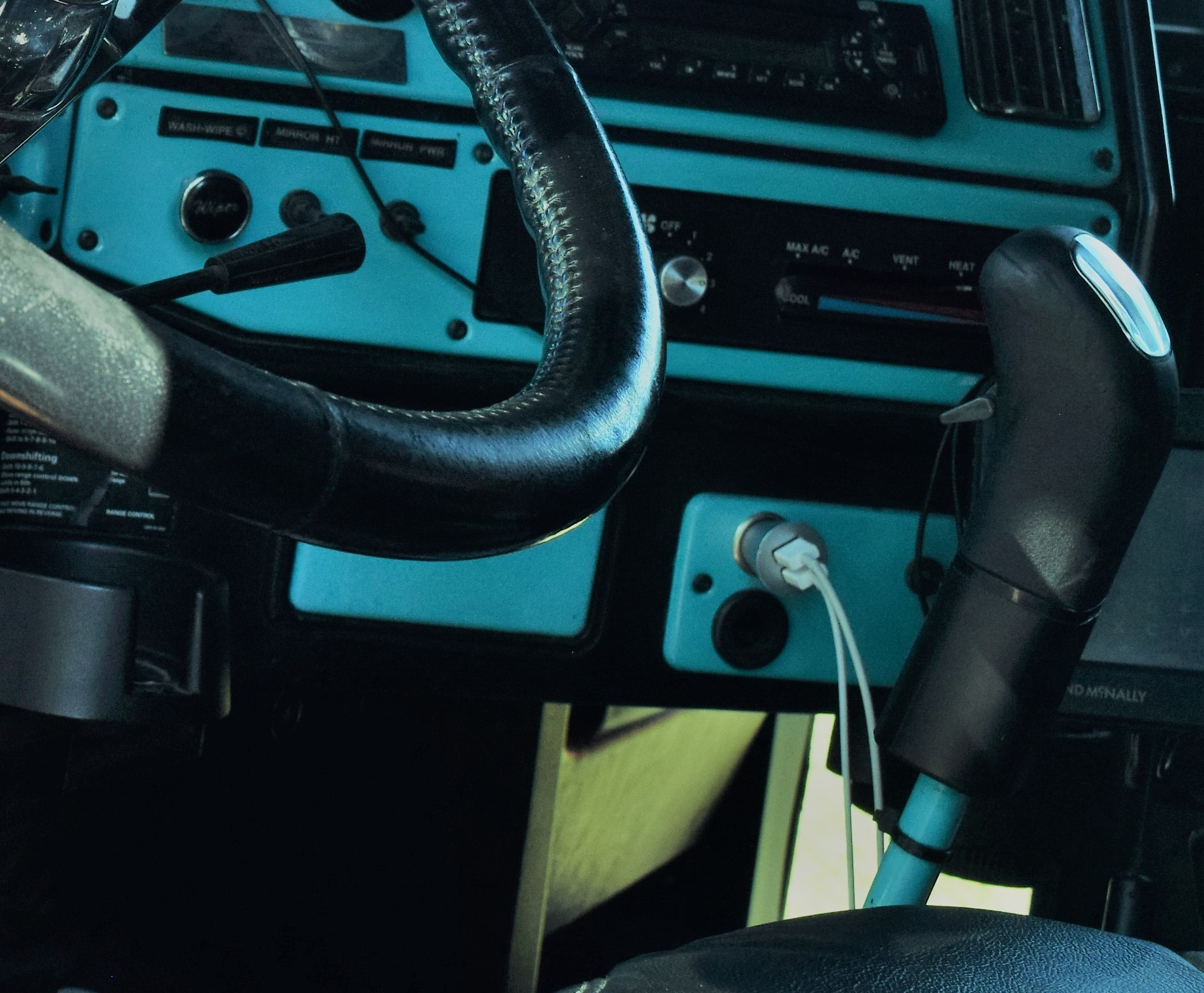Inside truck view of steering wheel and front dashboard
