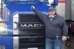Anthony Townley Sr. standing in front of a blue Mack semi-truck