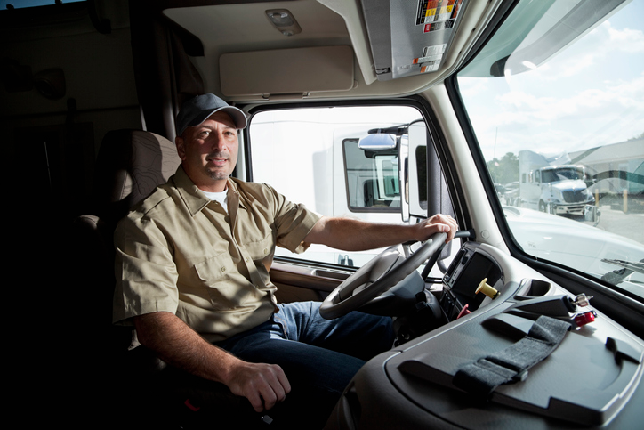 Truck driver in cab of semi-truck