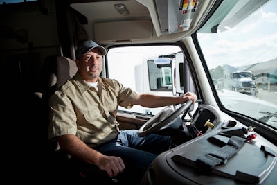 Truck driver in cab of semi-truck