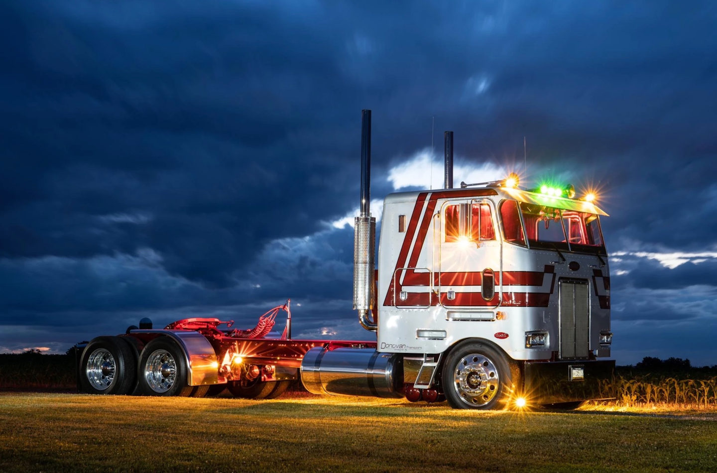 Peterbilt truck with lights glowing during dusk