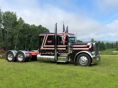 Peterbilt truck parked in grassy field