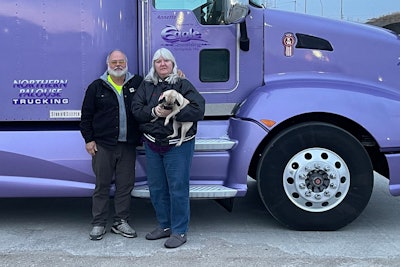 Phil and Annett Albert standing in front of their semi-truck