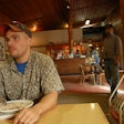 Man eating inside restaurant
