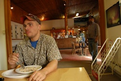 Man eating inside restaurant