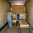 man unloading pallets into truck