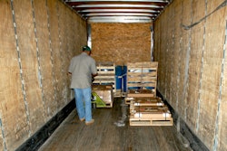 man unloading pallets into truck