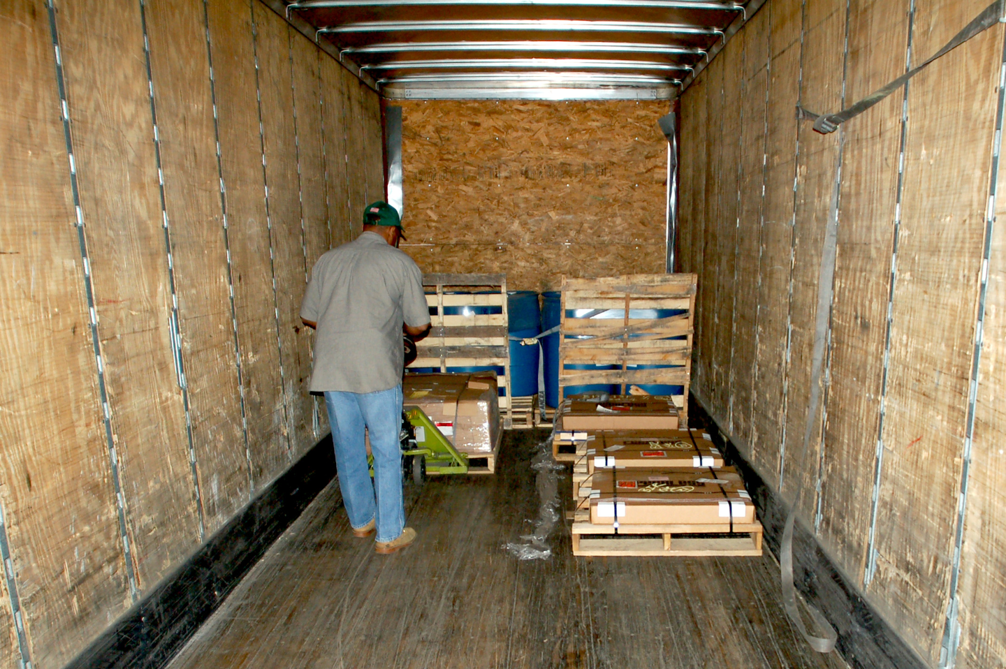 man unloading pallets into truck