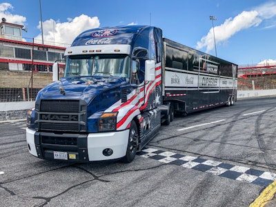 Military tribute NASCAR hauler unveiled | This Mack Anthem, featuring a custom-designed military-themed wrap, recently debuted as part of the 2021 edition of NASCAR Salutes Together with Coca-Cola. The annual campaign began the first weekend in May at Kansas Speedway in Kansas City, Kansas and continues through Memorial Day weekend at the Coca-Cola 600 at Charlotte Motor Speedway in North Carolina. It aims to express gratitude and respect for the men and women who serve in the United States Armed Forces and their families, as well as honor those who died defending freedom. “It’s an honor for Mack to once again be a part of NASCAR’s recognition of military heroes and their families,” said John Walsh, Mack Trucks vice president of marketing. “This year’s custom design is made even more special by the fact that it was chosen by NASCAR and Mack fans through a social media vote.” The winning design, featuring the five branches of the U.S. Armed Forces, captured 46% of the more than 3,300 votes lodged for competing designs. As the “Official Hauler of NASCAR,” Mack Trucks provides a fleet of 10 custom-designed Mack Anthem 70-inch stand-up sleeper models spec’d to meet the challenges of the NASCAR schedule. Each NASCAR Mack Anthem features a 505-horsepower MP8 engine and a Mack mDRIVE automated manual transmission.