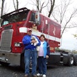 Steve and Doris Bixler having picture taken outside of truck