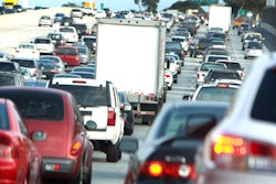 Trucks and cars in traffic.