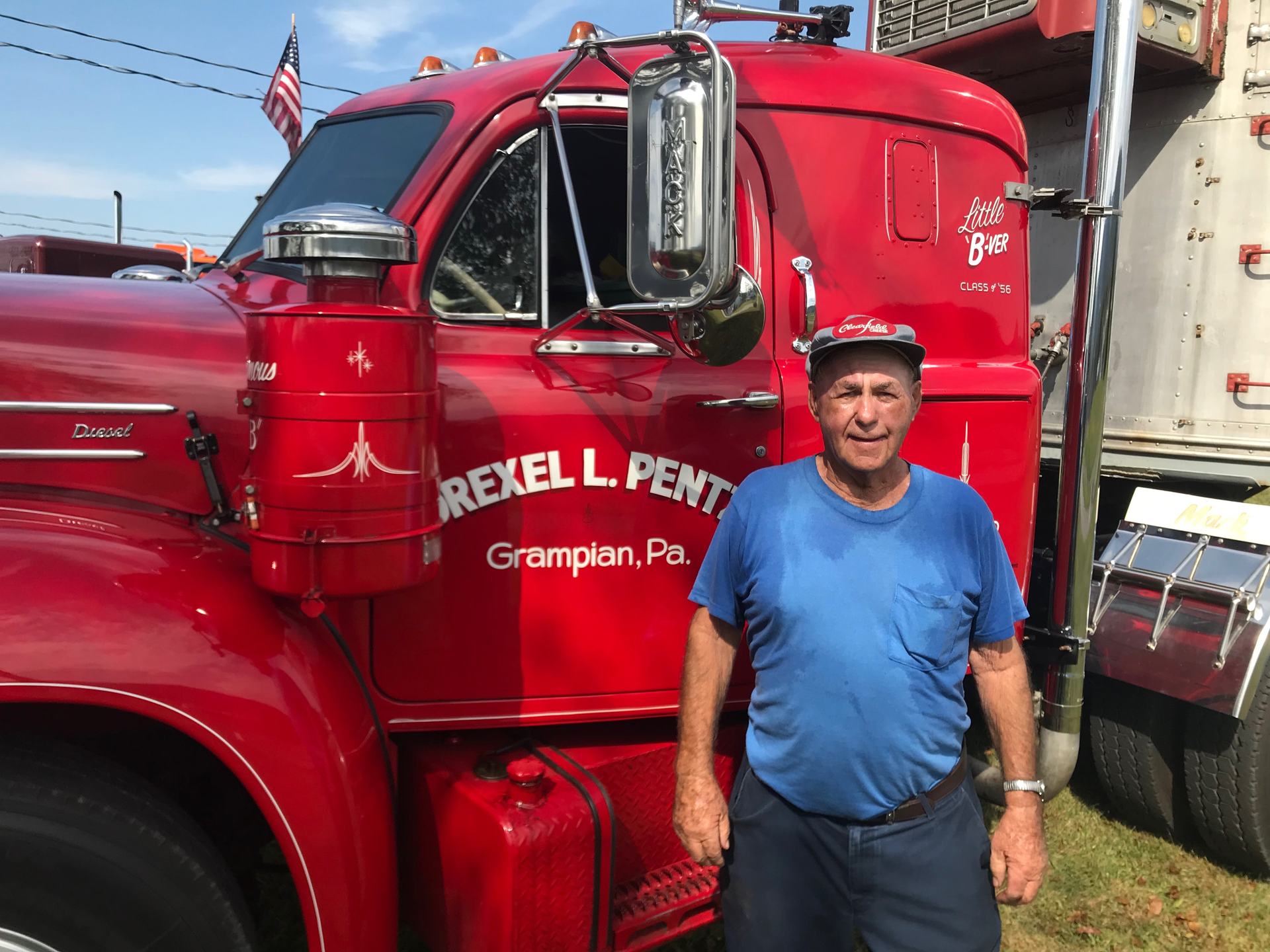 Man standing in front of semi truck driver side door