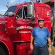 Man standing in front of semi truck driver side door