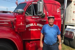 Man standing in front of semi truck driver side door