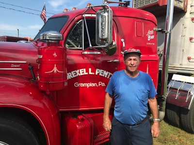Man standing in front of semi truck driver side door