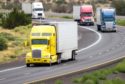 Four trucks driving on highway